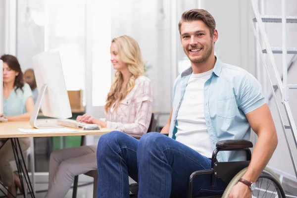 Businessman in wheelchair smiles to camera — Stock Photo, Image