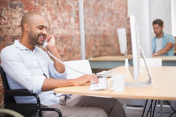 Businessman in wheelchair working — Stock Photo, Image