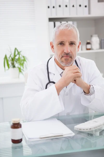 Doctor sitting at desk — Stock Photo, Image