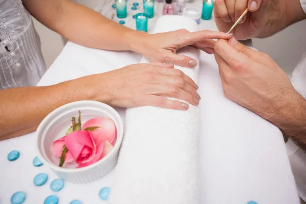 Manicurist cleaning customers nails — Stock Photo, Image