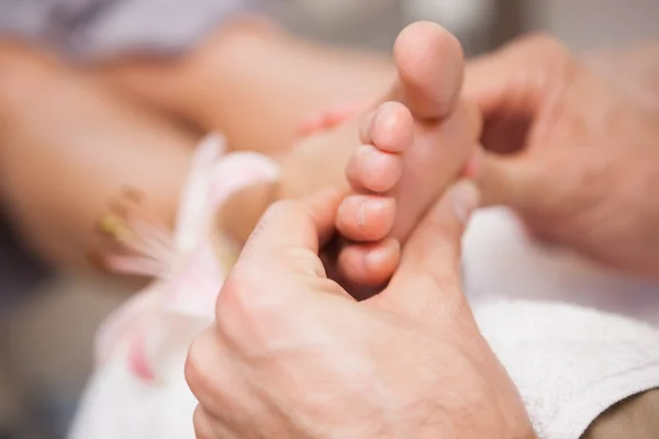 Pedicurist massaging customers foot — Stock Photo, Image