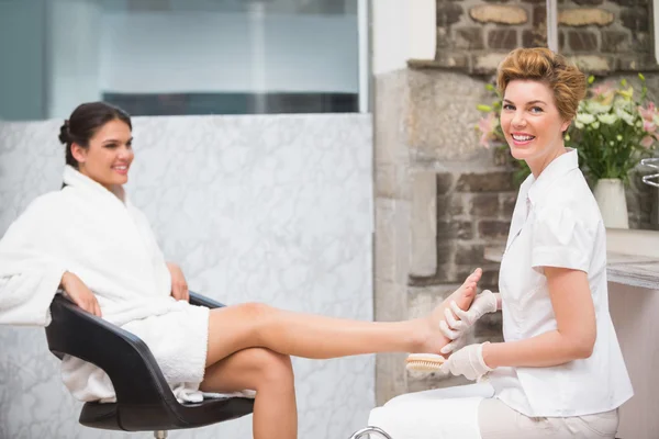 Kobieta coraz pedicure z kosmetyczka — Zdjęcie stockowe