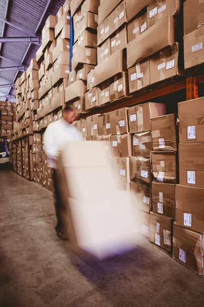 Worker with fork pallet truck stacker — Stock Photo, Image