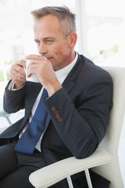 Businessman enjoying hot drink — Stock Photo, Image
