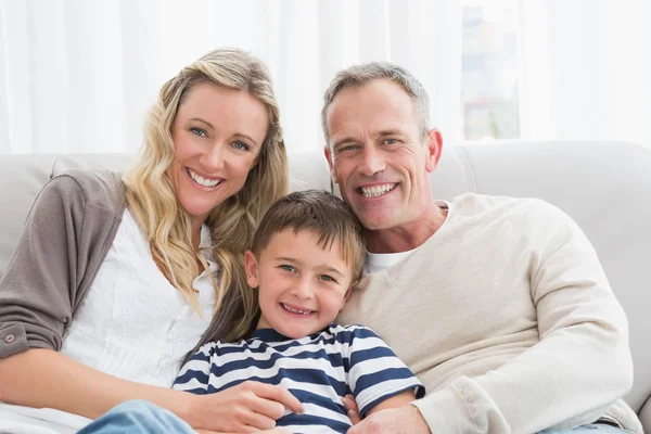 Genitori coccole figlio sul divano — Foto Stock