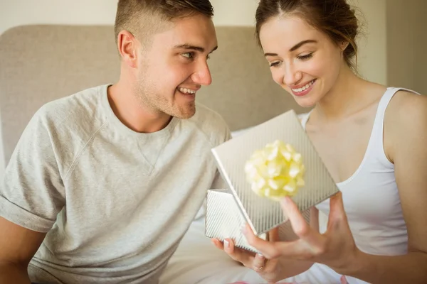 Girlfriend opening gift — Stock Photo, Image