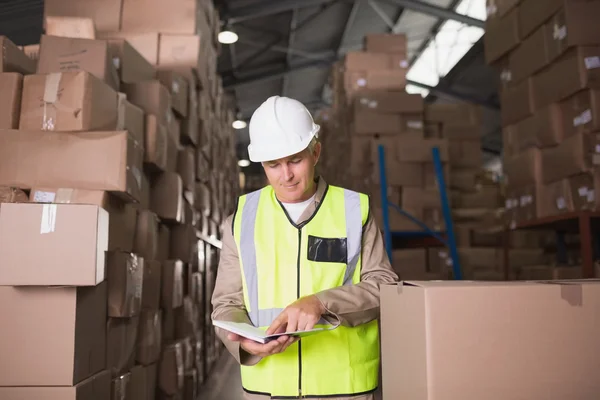 Worker standing against boxes — Stock Photo, Image