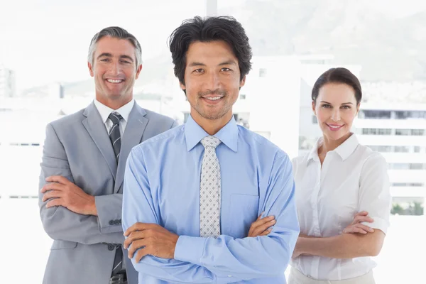 Business team standing with arms folded — Stock Photo, Image