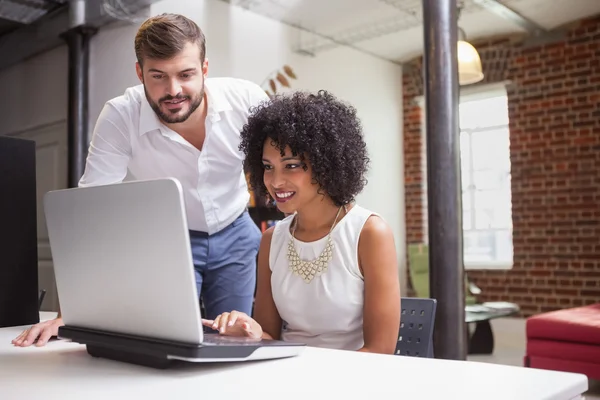 Business team looking at laptop — Stock Photo, Image