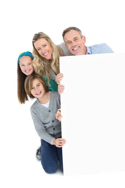 Family holding poster together — Stock Photo, Image