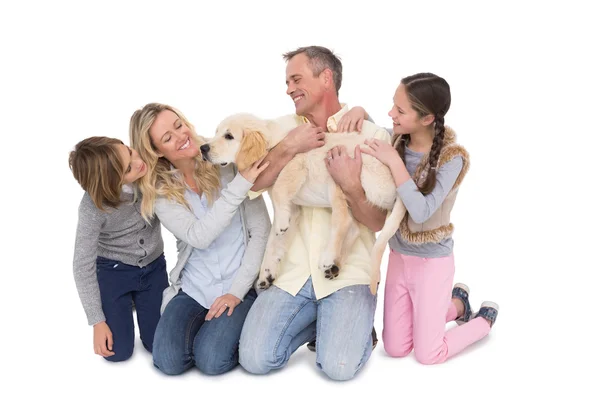 Family with dog posing and smiling together — Stock Photo, Image