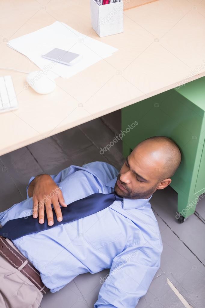 Businessman Sleeping Under Desk Stock Photo C Wavebreakmedia