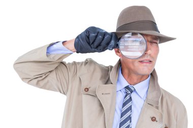 Spy looking through magnifier clipart