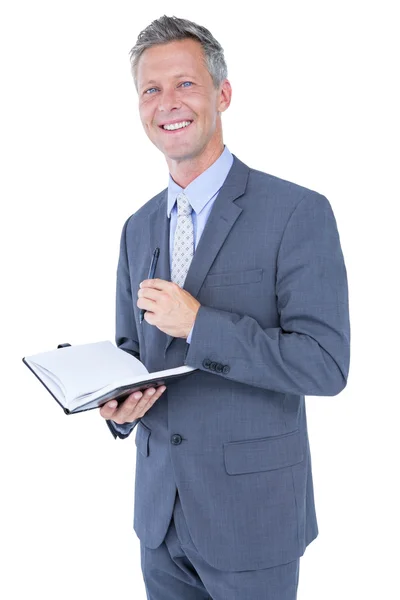 Affärsman med dagbok på vit — Stockfoto
