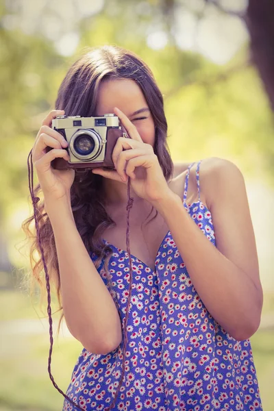 Brunette using retro camera — Stock Photo, Image