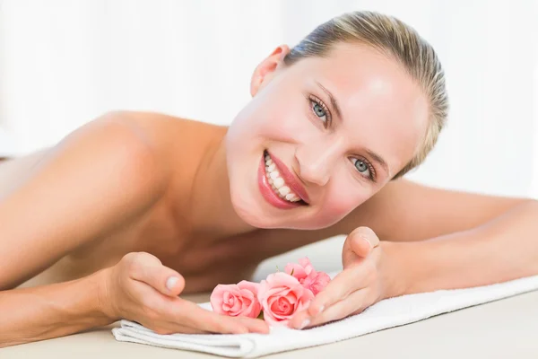 Peaceful blonde lying on towel smiling at camera — Stock Photo, Image