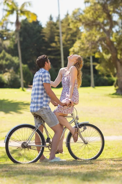 Young couple on a bike ride in the park — Stock Photo, Image