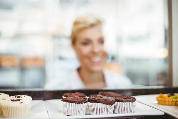 Mujer bonita mirando tortas de taza —  Fotos de Stock