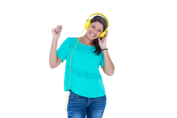 Happy pretty brunette listening music — Stock Photo, Image