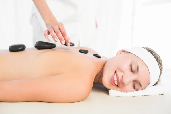 Blonde enjoying a hot stone massage — Stock Photo, Image