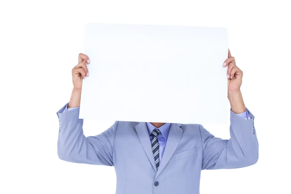 Businessman hiding face behind a blank panel Royalty Free Stock Photos