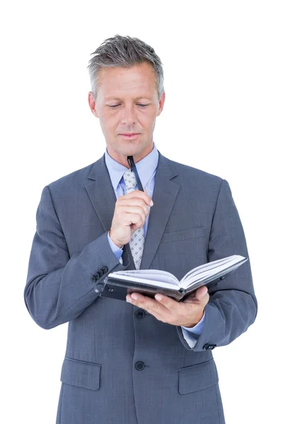 Geschäftsmann mit Tagebuch auf Weiß — Stockfoto