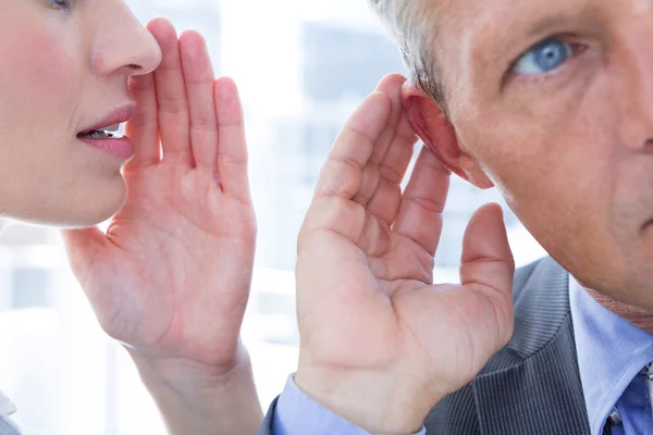 Business colleagues whispering — Stock Photo, Image