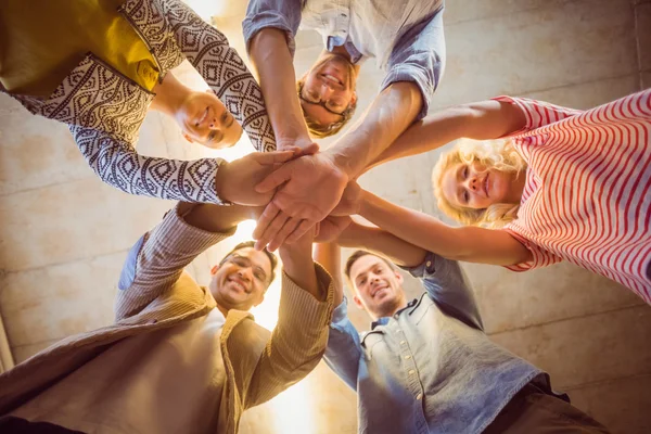 Happy business team joining their hands — Stock Photo, Image