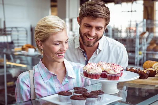 Cute couple on a date looking at cakes — Stock Photo, Image