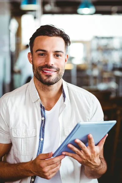 Man having cup of coffee using tablet — Stock Photo, Image