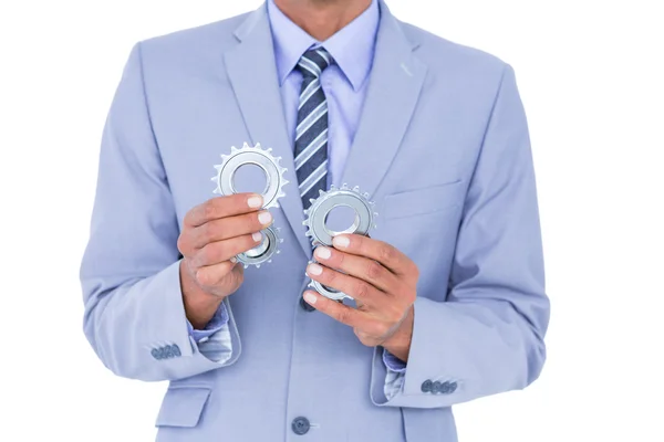 Businessman holding a gear — Stock Photo, Image