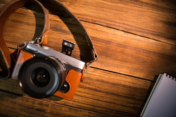 A beautiful fashioned camera next to the notepad — Stock Photo, Image