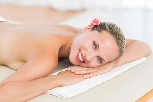 Peaceful blonde lying on towel smiling at camera — Stock Photo, Image