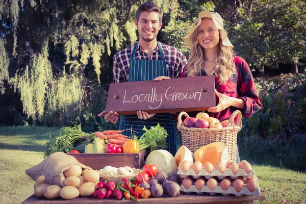 Happy farmers standing at their stall — Stock Photo, Image