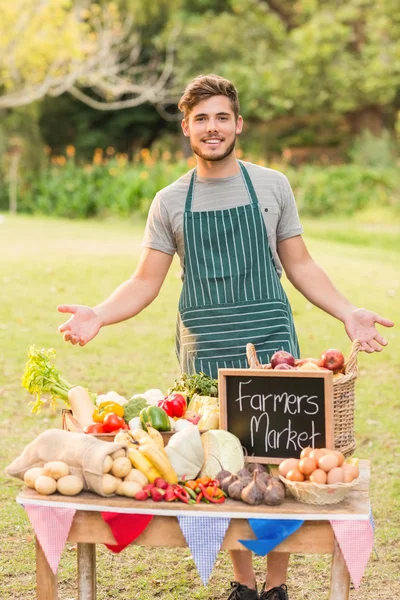 Handsome farmer standing at his stall — Stock Photo, Image