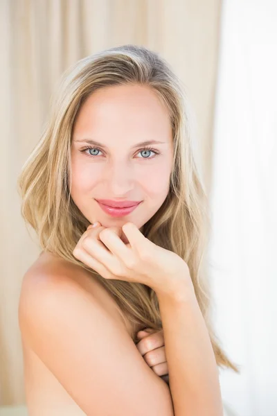 Blonde sitting on massage table — Stock Photo, Image