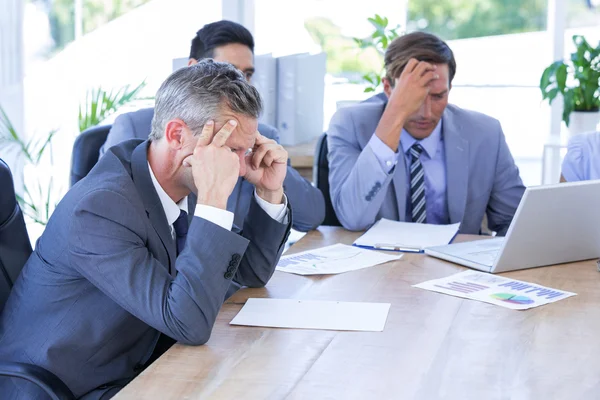 Colleagues with laptop and digital tablet in meeting — Stock Photo, Image