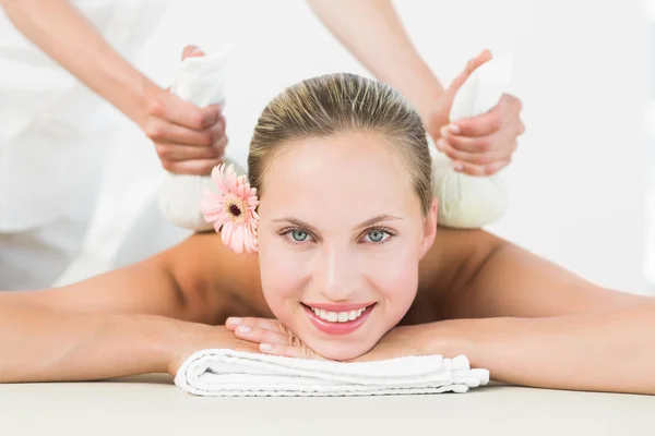 Blonde enjoying a herbal compress massage — Stock Photo, Image