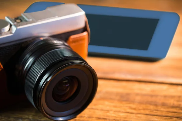 A beautiful brown fashioned camera next smartphone — Stock Photo, Image