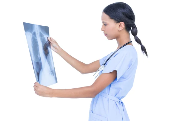 Serious young doctor looking at x-ray — Stock Photo, Image