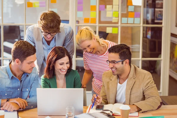 Happy creative business team using laptop in meeting — Stock Photo, Image