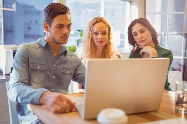 Group of young colleagues using laptop — Stock Photo, Image