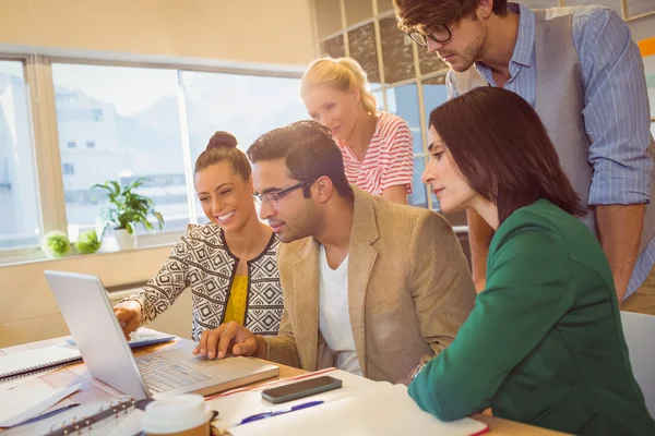 Colleagues using laptop in office — Stock Photo, Image