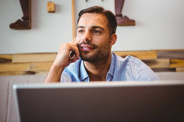 Smiling businessman using his laptop — Stock Photo, Image