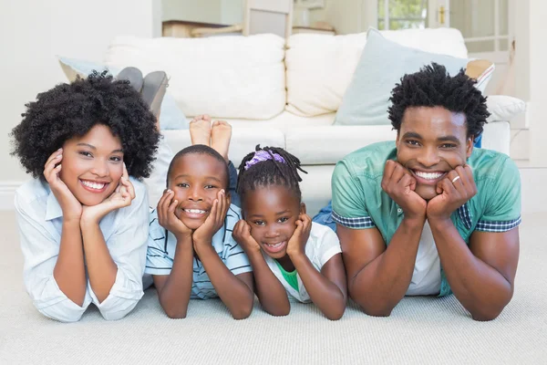 Famille heureuse couchée sur le sol — Photo