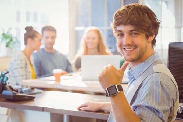 Portrait of smiling young businessman with colleagues — Stock Photo, Image