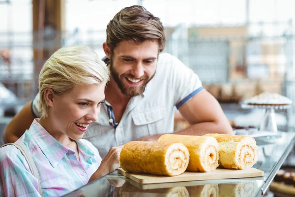 Cute couple on a date looking at cakes — Stock Photo, Image