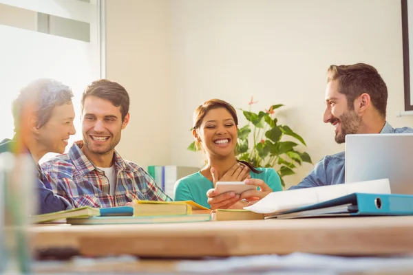 Groups of colleague looking at the smartphone — Stock Photo, Image