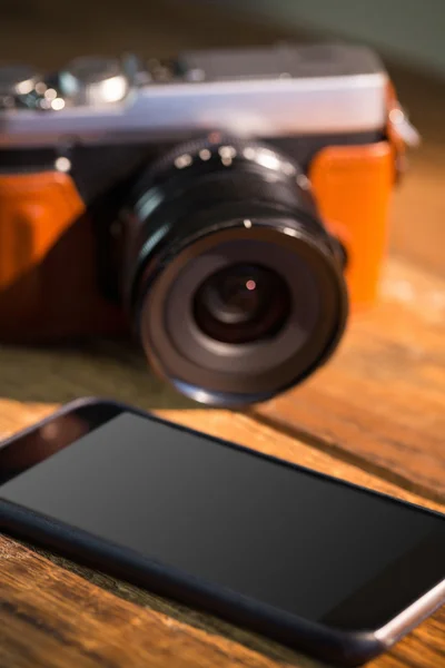 A beautiful brown fashioned camera next smartphone — Stock Photo, Image