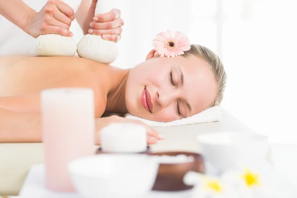 Blonde enjoying a herbal compress massage — Stock Photo, Image